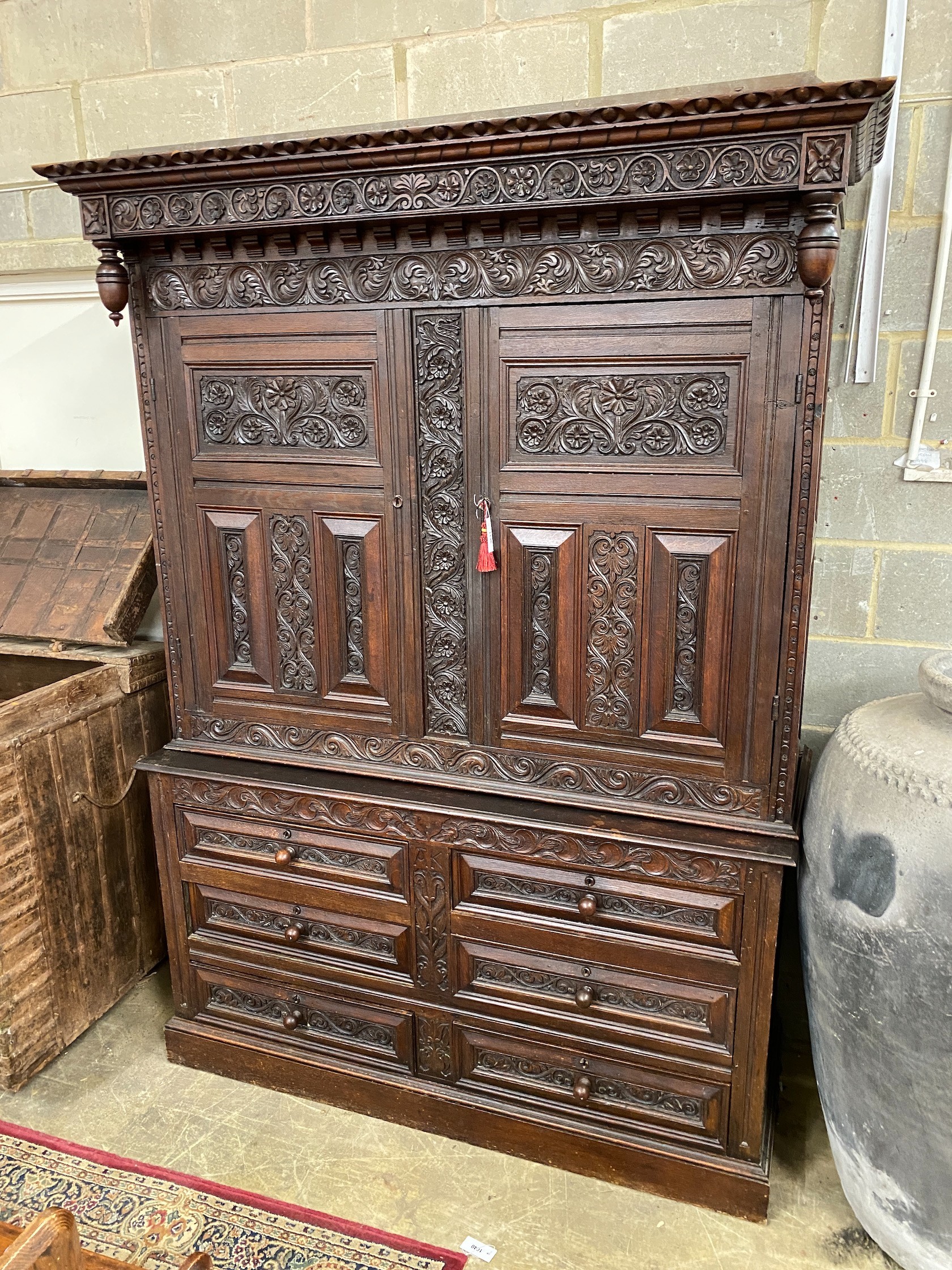 A large Flemish oak two part hanging cupboard, length 154cm, depth 55cm, height 219cm